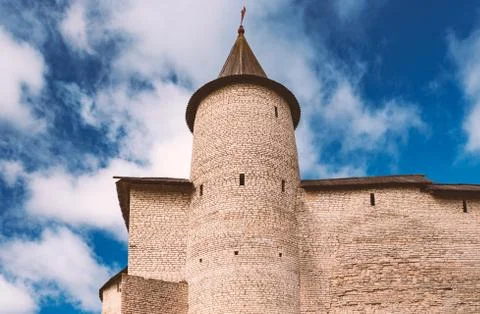 Pskov kremlin tower with blue cloudy sky Stock Photos