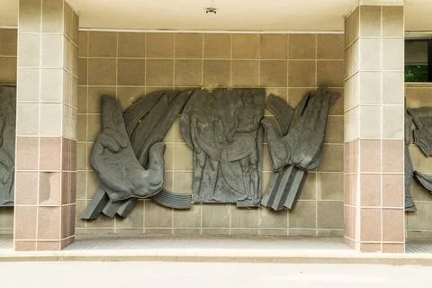 Pskov, Russia. Development of Communication bas-relief with dark metal pane.. Stock Photos