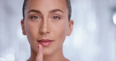 Psst - a beautiful girl making a shusing gesture raising her finger Stock Footage 78261602