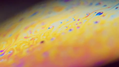 Psychedelic dye gasoline fluid pink orange slick Video stock 288744495