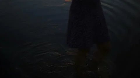 Psychedelic effect girl walking barefoot in the water in the evening Stock Footage 68821277