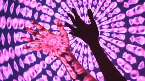 Psychedelic hand with shadow on wall. Projected film on models hand. Stock Footage 77582774