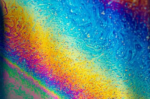 Psychedelic multicolours as light refracts through liquid soap Stock Photos