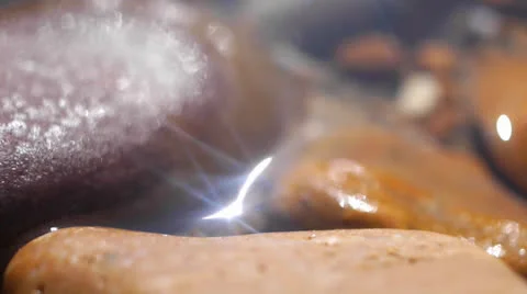 Psychedelic Nature Close Up Shimmering Sunlight Between Pebbles on Beach Stock Footage 25891941