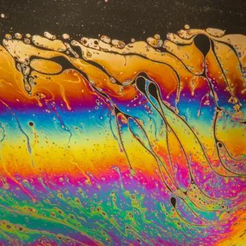 Psychedelic patterns formed on the surface of soap bubbles Stock Photos