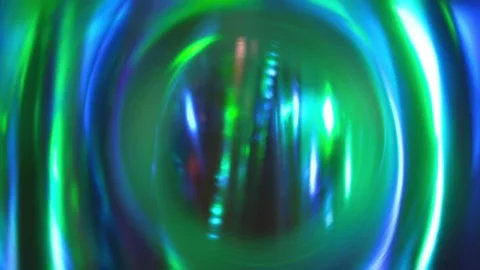 A psychedelic vortex of neon green and blue colors twists through layers of Video stock 303781513