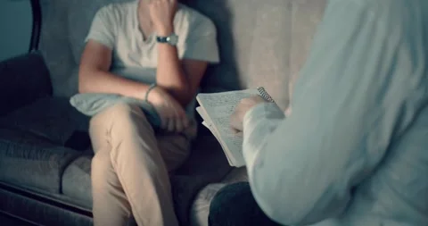 Psychiatrist Taking Notes During Session With Depressive man. Psychology Stock Footage 260938035