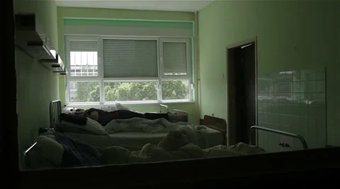 Psychiatry. Psychiatric ward. Patient lying in bed on clinic for mental illness. Stock Footage