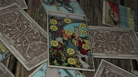 Psychic forecasting wealth by casting a spell on a Ten of Pentacle card Stock Footage 219505485