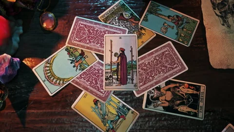 Psychic performing the fortune forecasting spell with Two of Wands card Stock Footage 250781786