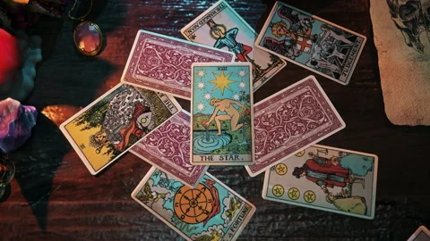Psychic performs mystic The Star Tarot Card reading predicting future luck Stock Footage 250779062
