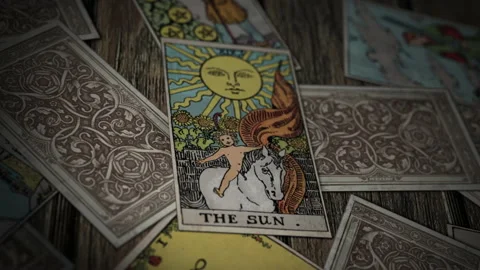 Psychic is reading the ritual Magic Tarot Card The Sun for fortune prediction Stock Footage 238601205