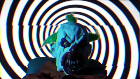 Psycho Clown against hypnotic rotating black spiral background Stock Footage 222909843