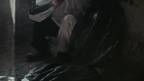 Psycho Clown Hitting Dead Body in Trash Bag Stock Footage 250951518