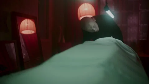 Psycho man in a dark room looking at a corpse Stock-Footage 259848962