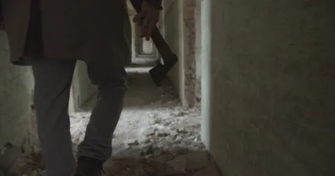 Psycho serial killer with ax walking in dark hallway close up,horror movie scene Stock Footage 163704697