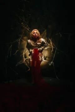 A psycho in a straitjacket vomits on a black background in the Studio Foto stock