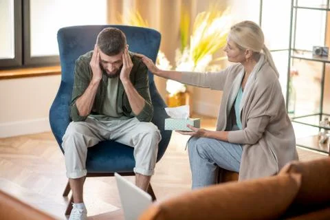 Psychoanalyst supporting client who feeling very depressed Stock Photos