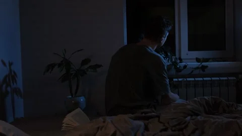 Psychological disorders and problems. Silhouette of a man in despair sitting on  Stock Footage 296882836
