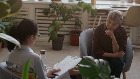 Psychologist Analyzing Colored Human Body Diagram during Cancer Counseling Stock Footage 330670511