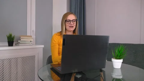 Psychologist conducts session with clients remotely through laptop. Online Stock Footage 231329124