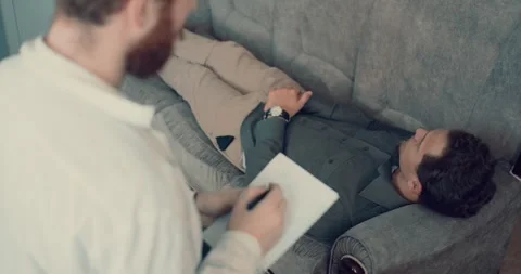 Psychologist Making Notes During Therapy Session With Depressed Soldier. Army Stock Footage 260937776