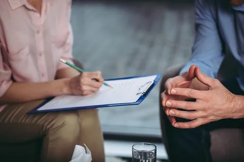 Psychologist making notes Stock Photos