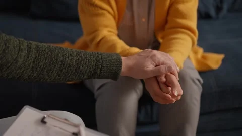 Psychologist sitting and touch hand young depressed woman for encouragement on Stock Footage 240931762