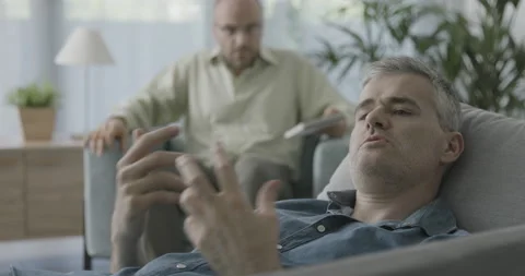 Psychologist sneaking away during a session Stock Footage 162355488