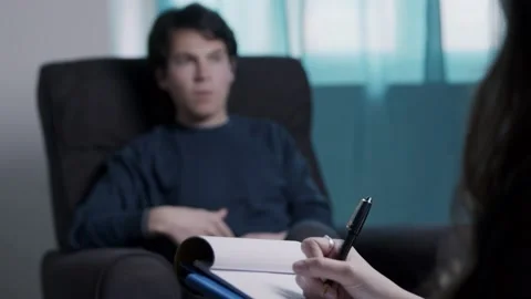 Psychologist takes note while the patient talks about his problems Stock-Footage 182985822