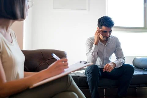 Psychologist taking notes during therapy session. Stock-Fotos