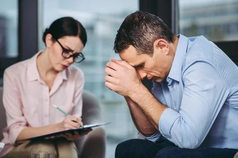 Psychologist talking with patient Stock Photos