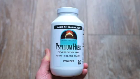 Psyllium husks supplement bottle bowel movement constipation by Source Naturals Stock Footage 336781143