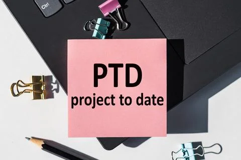 PTD - Project To Date acronym, note is written on a paper sticker on a lapt.. Stock Photos