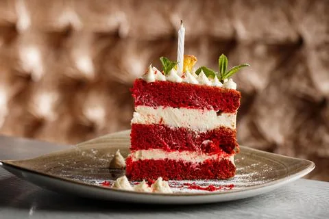 Pte on grey tabletop. Slice of delicious homemade red velvet cake with raspbe Stock Photos