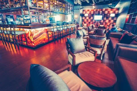 Pub interior design: modern place with armchairs and tables for people resting Stock Photos