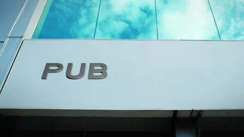 Pub Sign on Modern Building with Cloud Reflection on Windows Glass Stock Footage 303565362