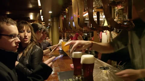 Pub Staff Preparing Stout Beer Pints Behind Bar Handheld shot Видео 344030355