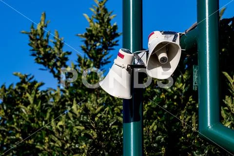 Public address bullhorn outdoor speakers on a green Stock Photos
