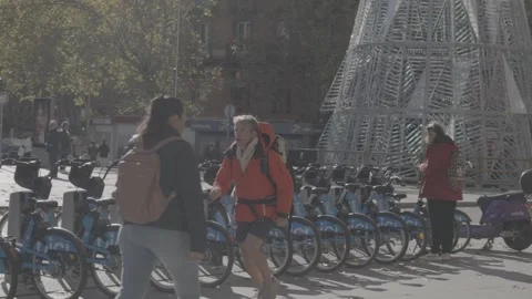 Public bicycles and a man running in Madrid, Spain Stock-Footage 345029244