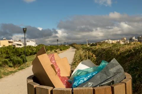 A public bin full of trash Stock Photos
