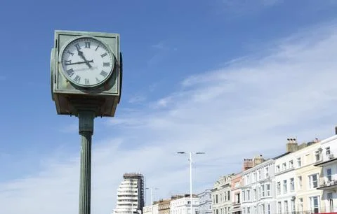 A public clock on the seafront at St Leonards, East Sussex, UK. Stock Photos
