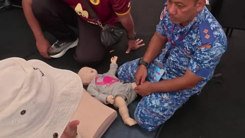Public CPR and First Aid Demonstration by Rescuers at Community Carnival Stock Footage 340986606