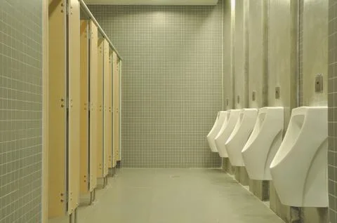 Public empty restroom with gray ceramic wall. Foto stock