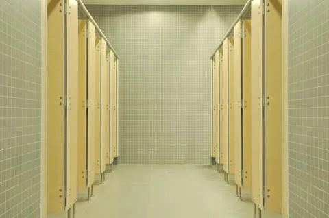 Public empty restroom with gray ceramic wall. Stock Photos