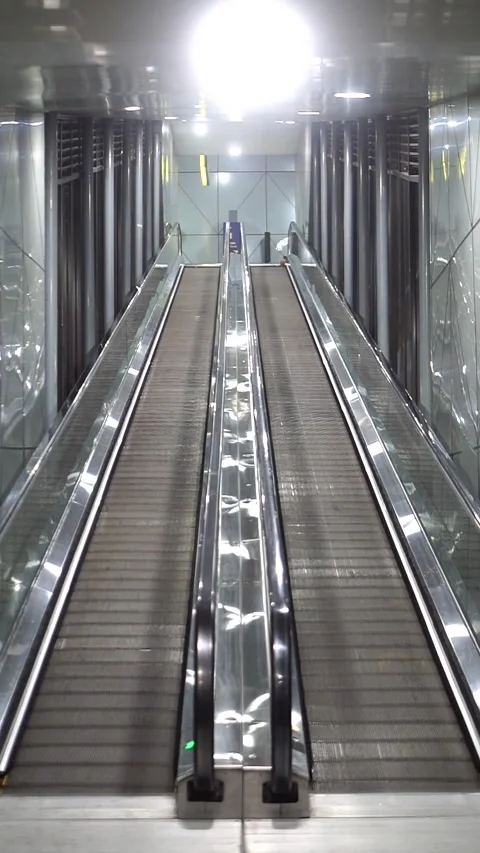 Public facility interior featuring clean escalators and contemporary Stock Footage 333031124