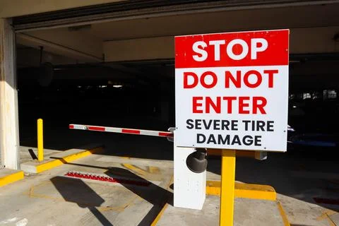 Public Garage Exit with "STOP Do Not Enter, Severe Tire Damage" Sign Stock-Fotos