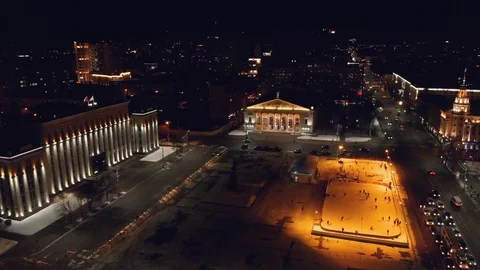 Public ice rink with skating people in city near asphalt road with cars in Stock-Footage 102628341