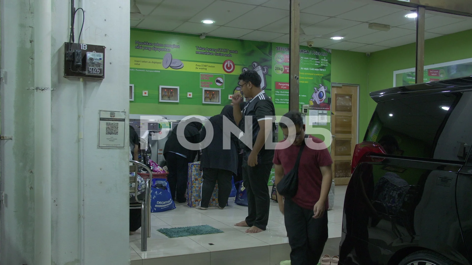 Public laundry machines in Chang Lun Malaysia as patrons load laundry