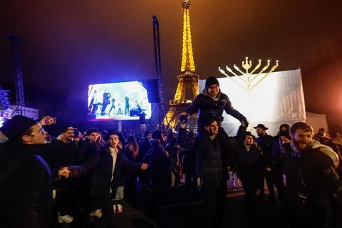 Public menorah lighting for Hanukkah at the Eiffel Tower in Paris, France - 29 D Stock Photos